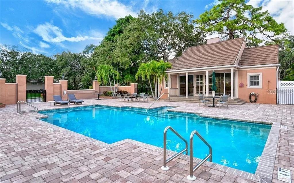 60 Bishopscourt Road, Unit 114 Osprey, FL 34229 - Photo 31 of 33 a view of a house with swimming pool and sitting area