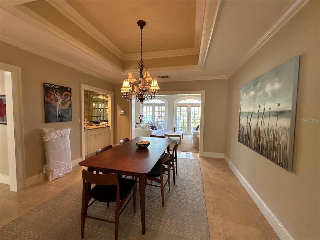 60 Bishopscourt Road, Unit 114 Osprey, FL 34229 - Photo 6 of 33 a view of a dining room with furniture and chandelier