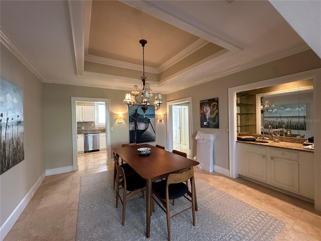 60 Bishopscourt Road, Unit 114 Osprey, FL 34229 - Photo 7 of 33 a view of a dining room with furniture window and wooden floor