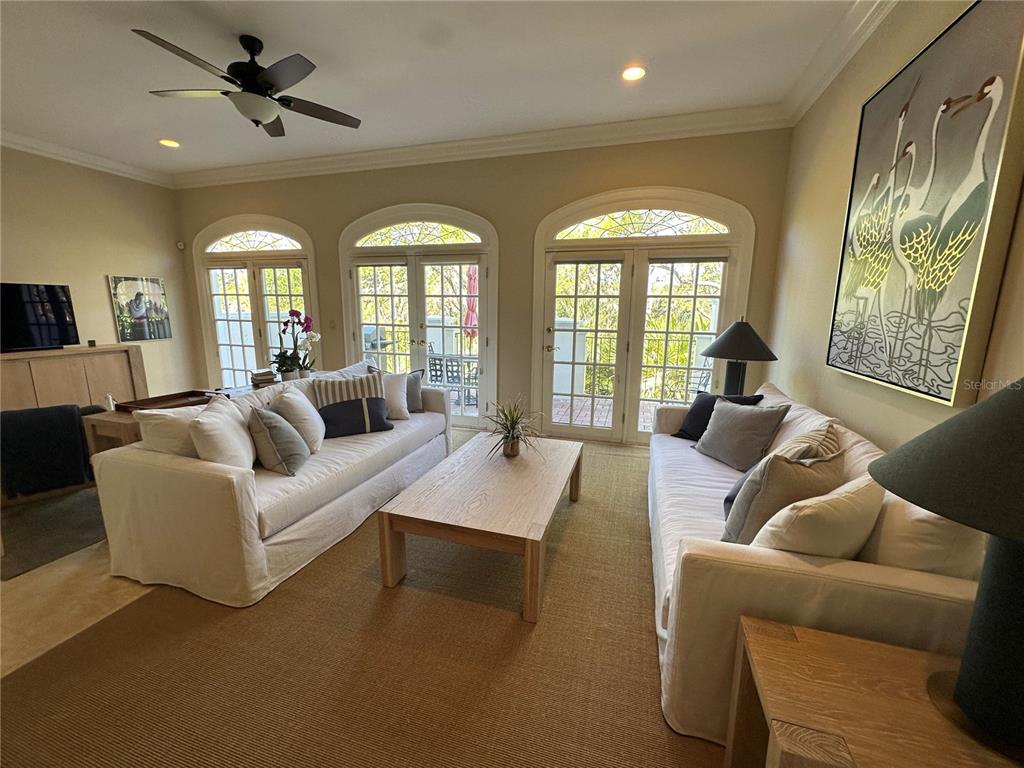 60 Bishopscourt Road, Unit 114 Osprey, FL 34229 - Photo 10 of 33 a living room with furniture and a large window