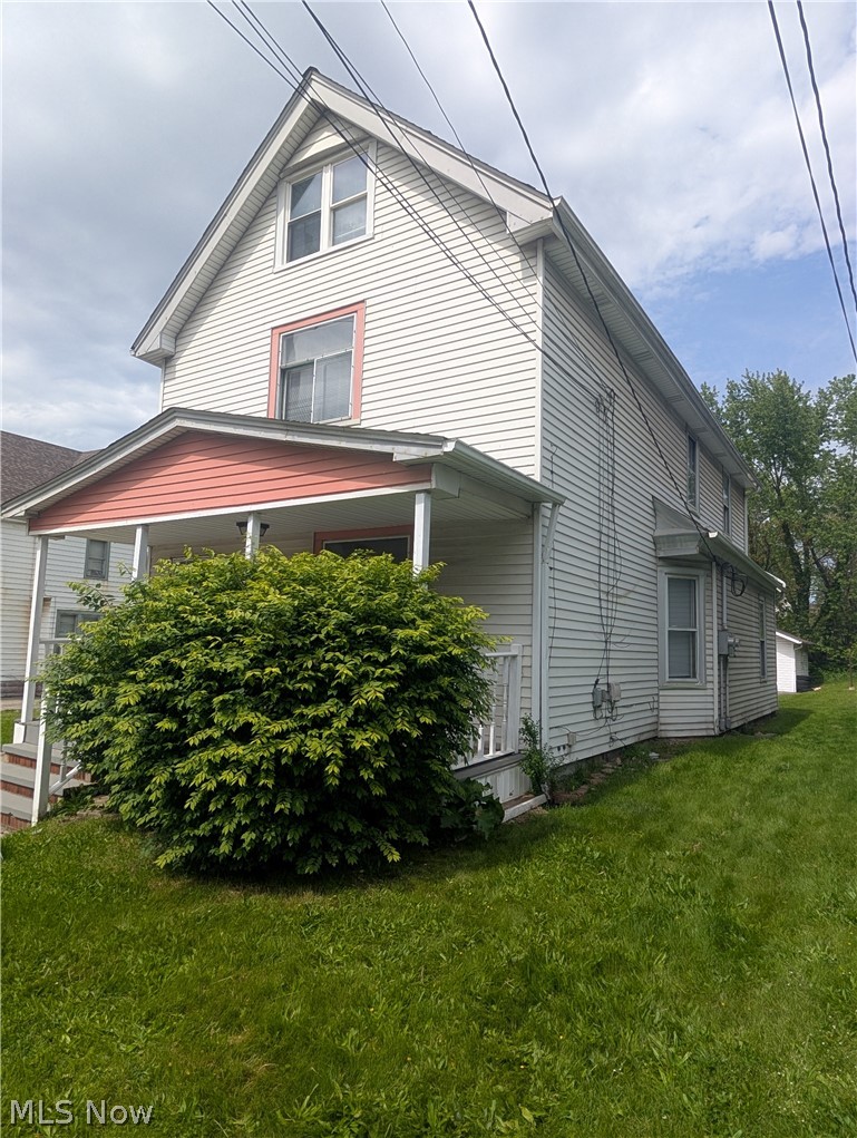 7515 Ottawa Road Cleveland, OH 44105 - Photo 3 of 21 Traditional two-story residence featuring light-colored siding and a contrasting porch roof