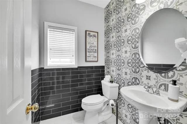 a bathroom with a sink toilet and mirror
