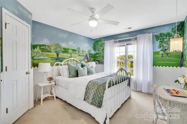 a bedroom with a bed and a large window