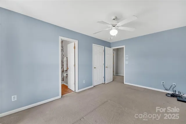 a view of a livingroom with a ceiling fan and window