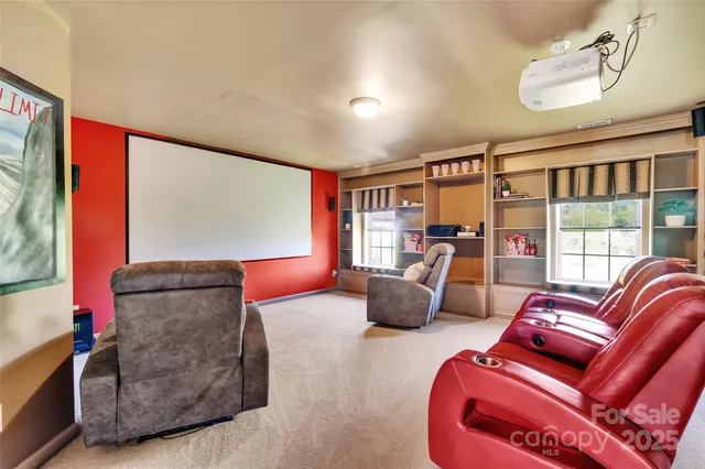 a living room with furniture ceiling fan and a large window