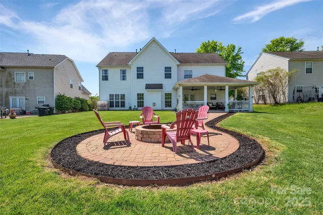 a view of a house with a swimming pool and a yard
