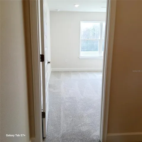a view of a small space with wooden floor and a window