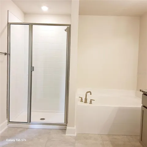 a bathroom with a bathtub and shower
