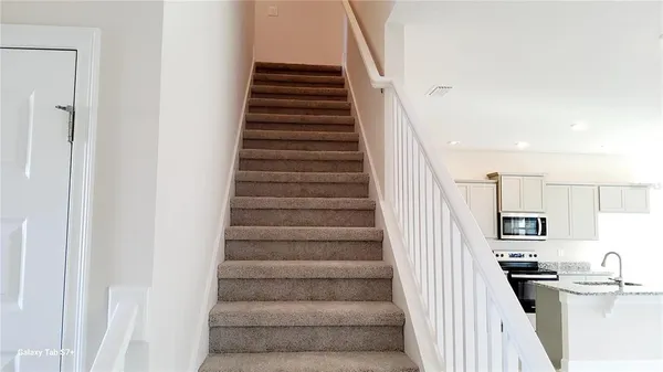 a view of a kitchen with furniture and staircase
