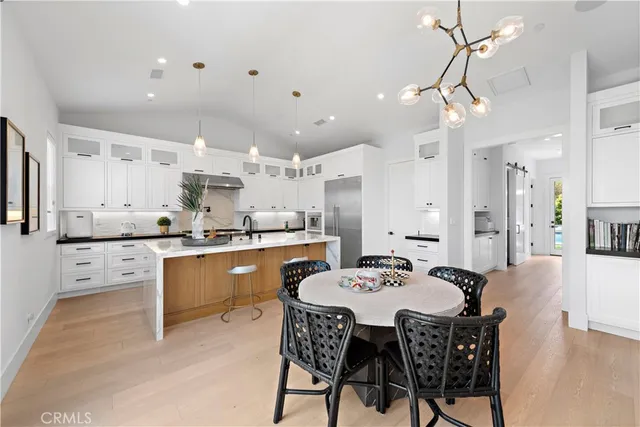 a living room with furniture or chandelier and a wooden floor