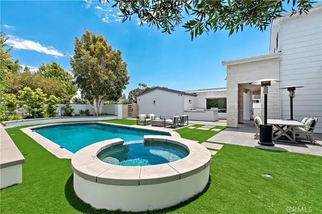 a view of a patio with table and chairs potted plants with wooden floor and fence