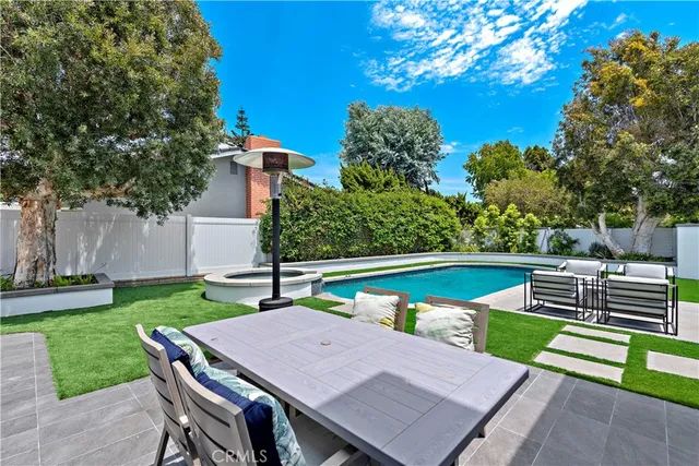 a view of a patio with couches chairs potted plants and a palm tree