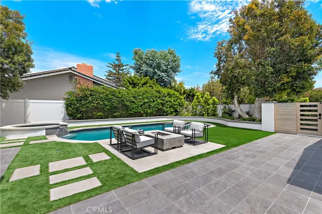 a view of a house with backyard porch and sitting area