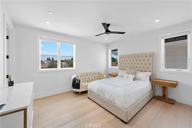 a bedroom with a bed and a large window