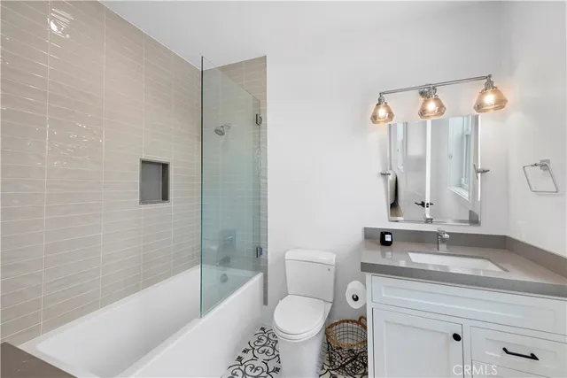 a bathroom with a sink and mirror with toilet
