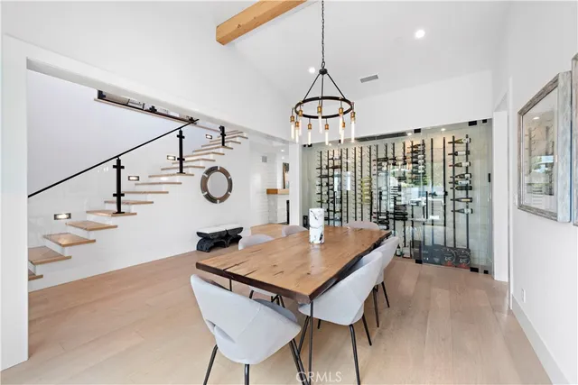 a dining room with furniture window entryway and wooden floor
