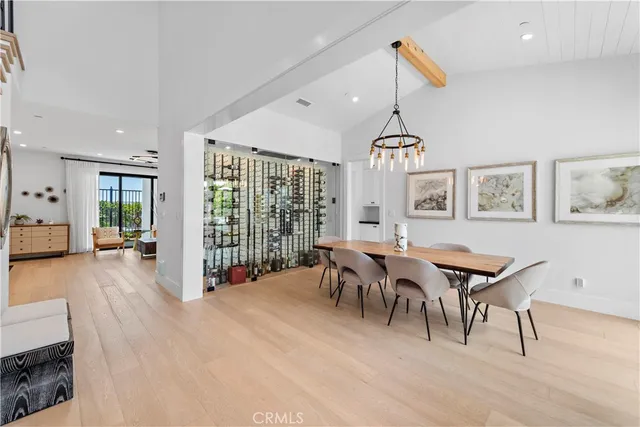 a kitchen with stainless steel appliances granite countertop a sink a stove a refrigerator cabinets and dining table