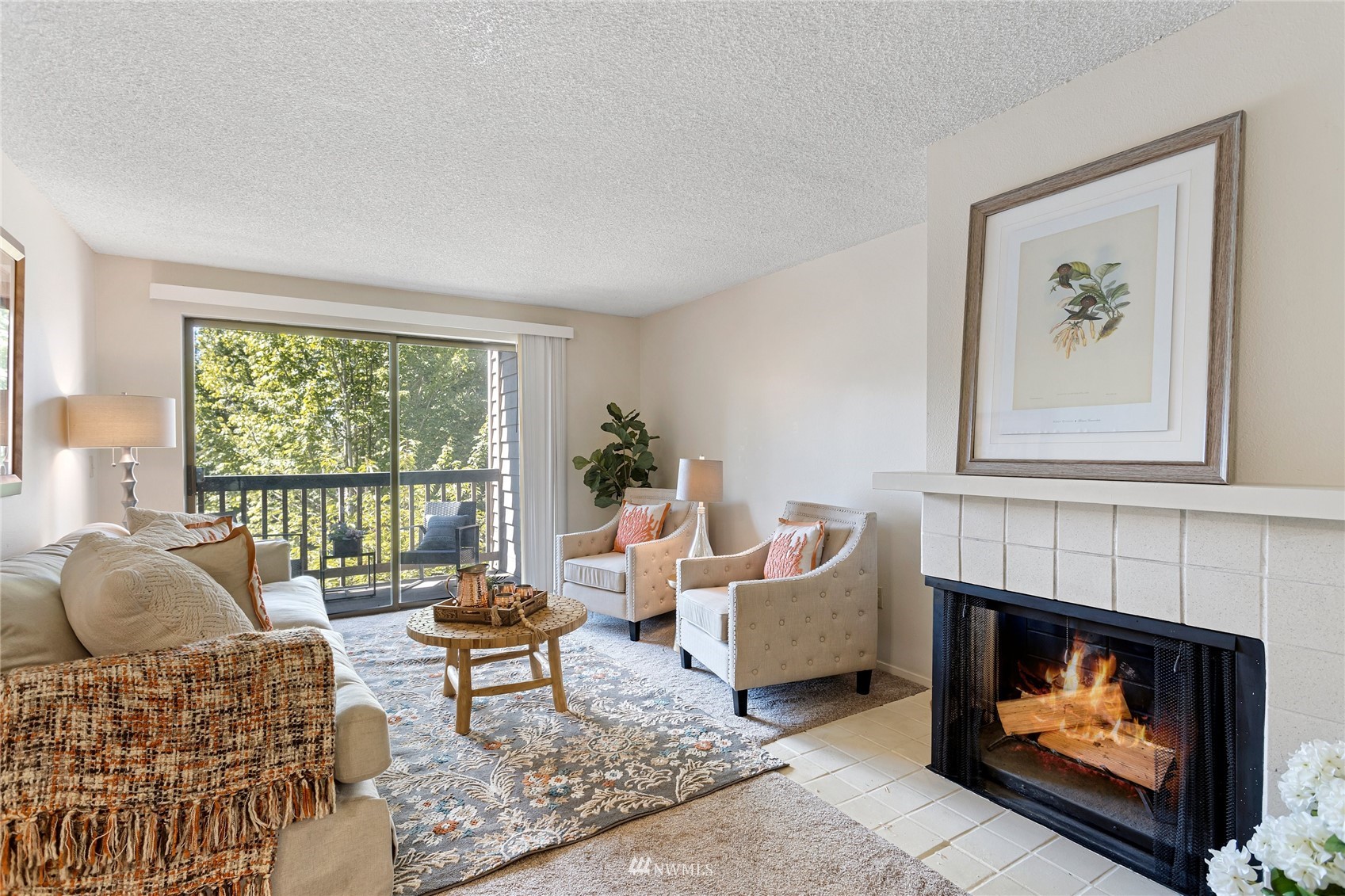 611 Southwest 5th Court, Unit A304 Renton, WA 98057 - Photo 1 of 23 a living room with furniture a window and a fireplace