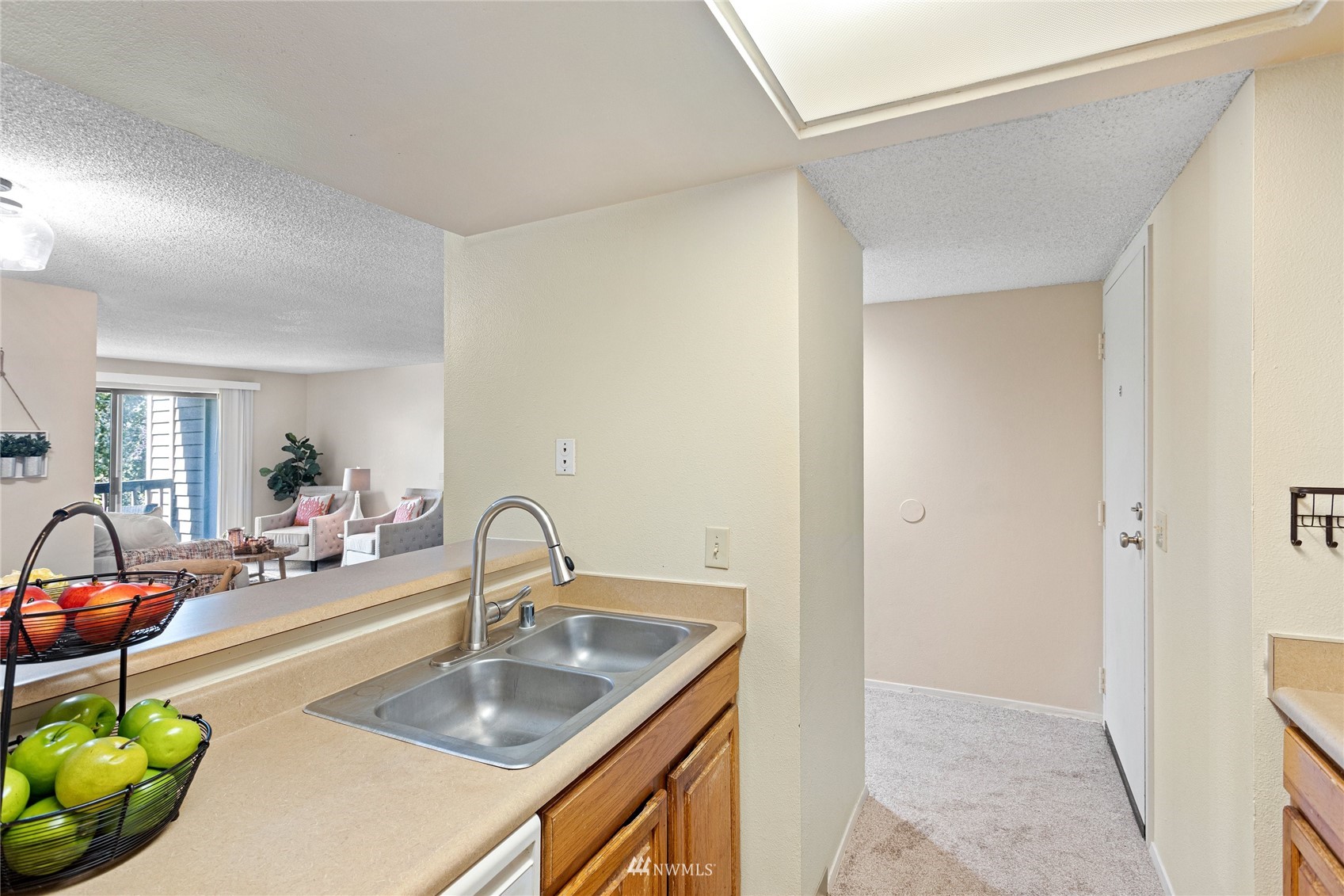 611 Southwest 5th Court, Unit A304 Renton, WA 98057 - Photo 12 of 23 a kitchen with sink a table and chairs