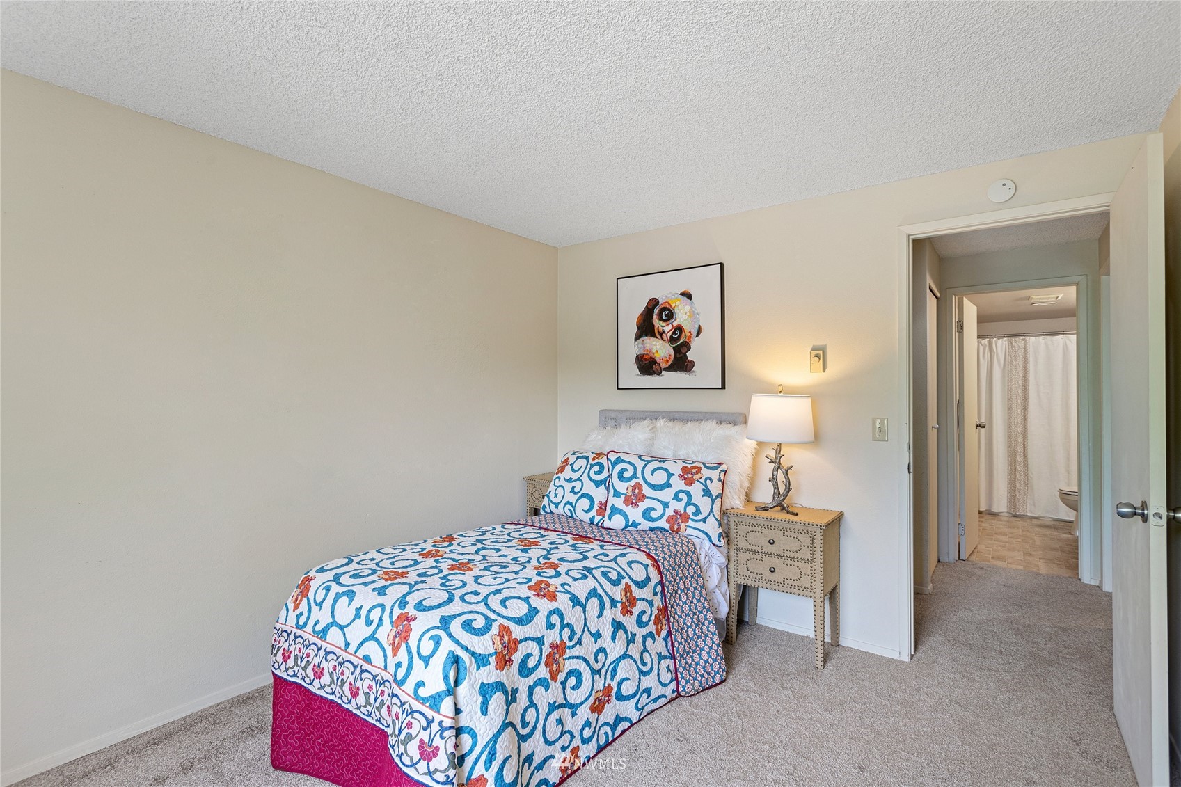 611 Southwest 5th Court, Unit A304 Renton, WA 98057 - Photo 14 of 23 a bedroom with a bed and a painting on the wall