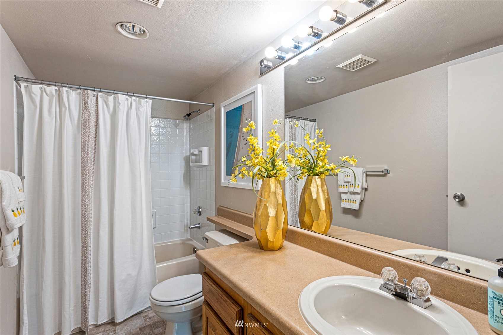 611 Southwest 5th Court, Unit A304 Renton, WA 98057 - Photo 15 of 23 a bathroom with a granite countertop sink a toilet and a mirror