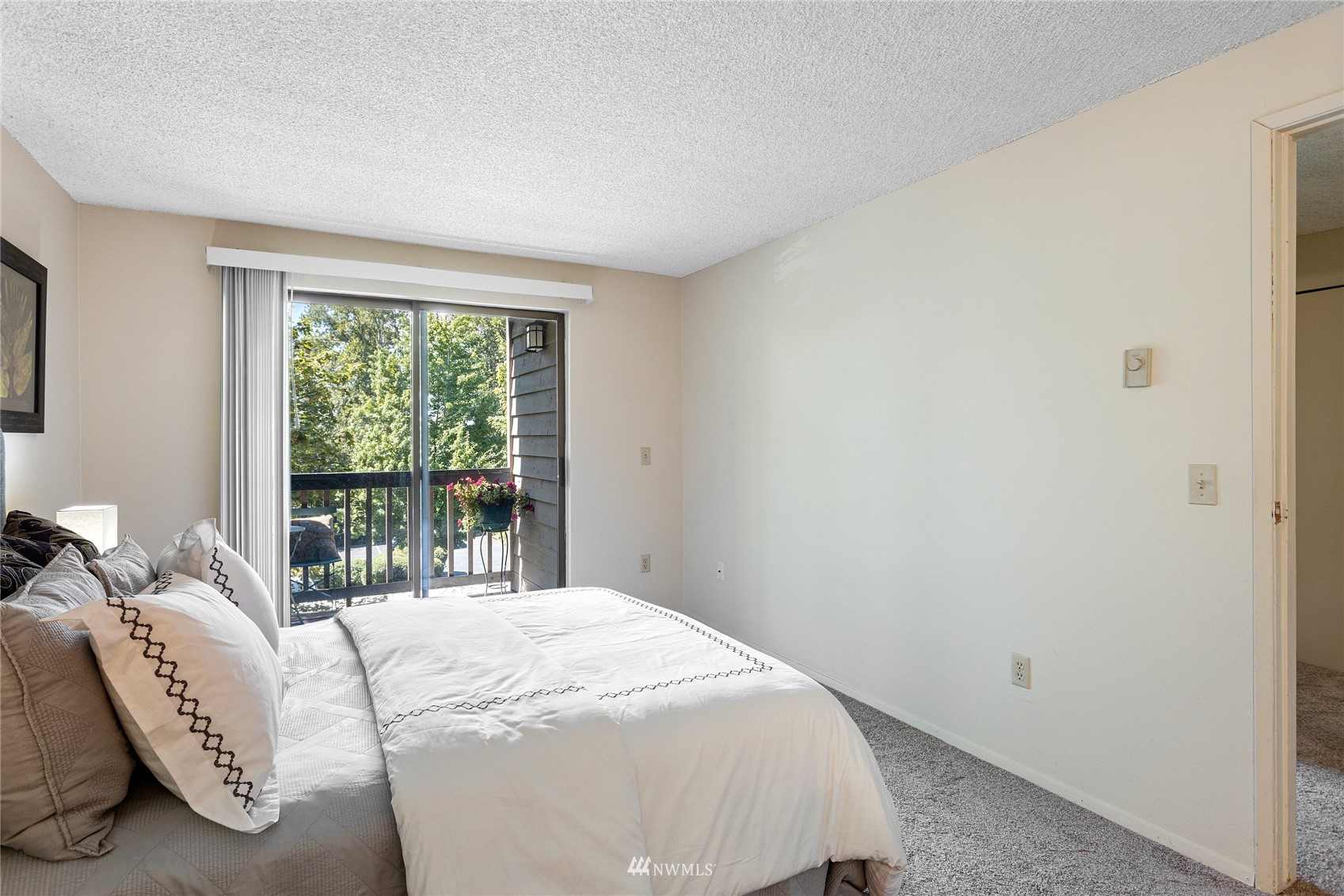 611 Southwest 5th Court, Unit A304 Renton, WA 98057 - Photo 17 of 23 a bed sitting in a bedroom next to a window