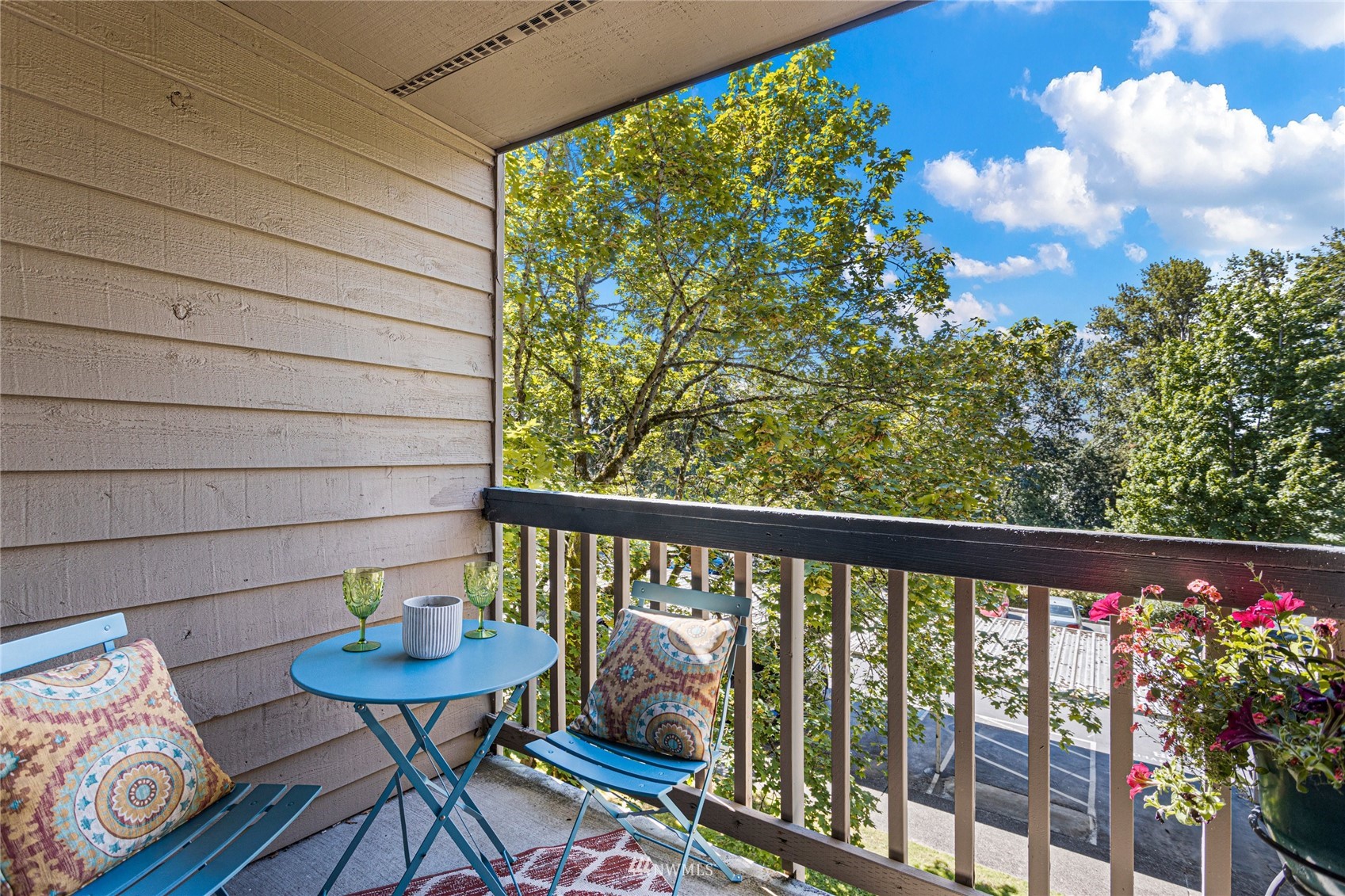 611 Southwest 5th Court, Unit A304 Renton, WA 98057 - Photo 18 of 23 a view of a balcony with chairs and a potted plant