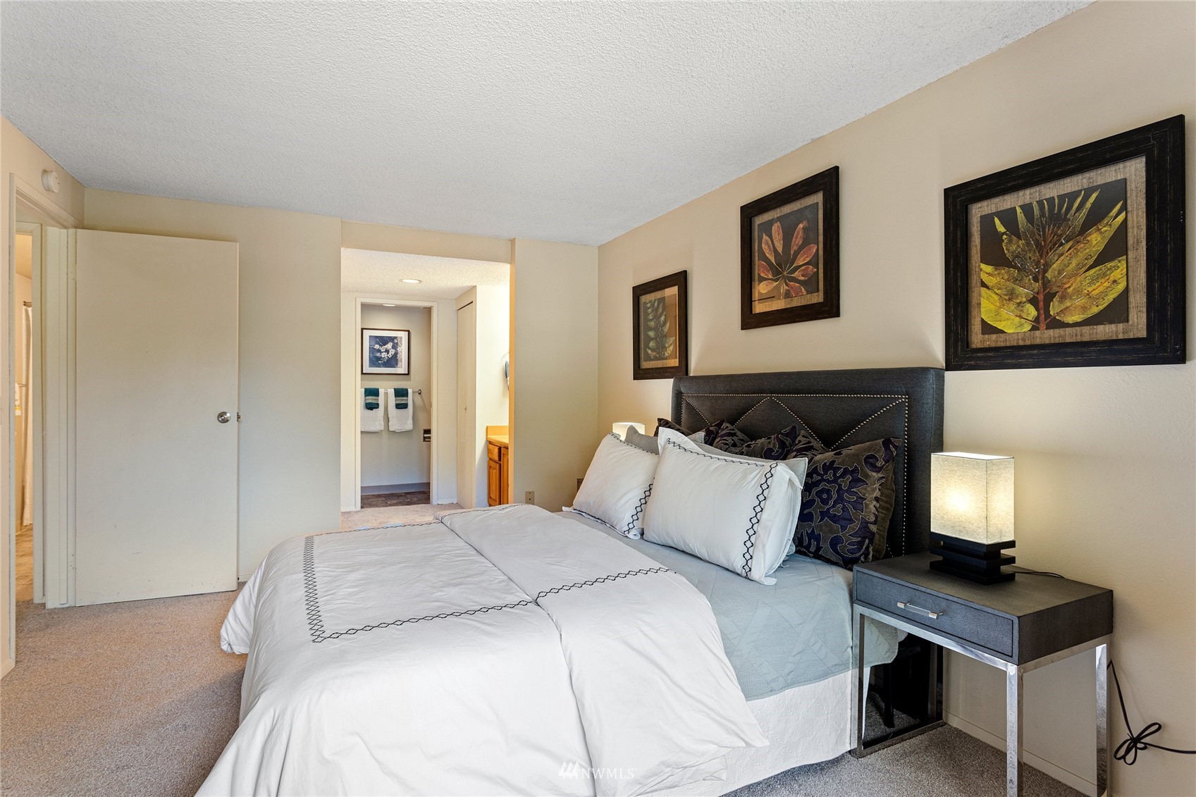 611 Southwest 5th Court, Unit A304 Renton, WA 98057 - Photo 19 of 23 a bedroom with a bed and paintings on the wall