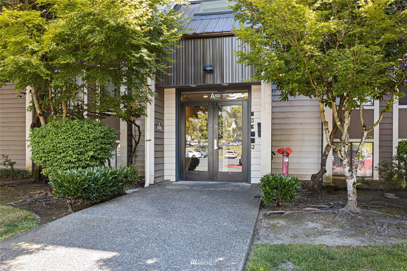 611 Southwest 5th Court, Unit A304 Renton, WA 98057 - Photo 22 of 23 a front view of a house with garden