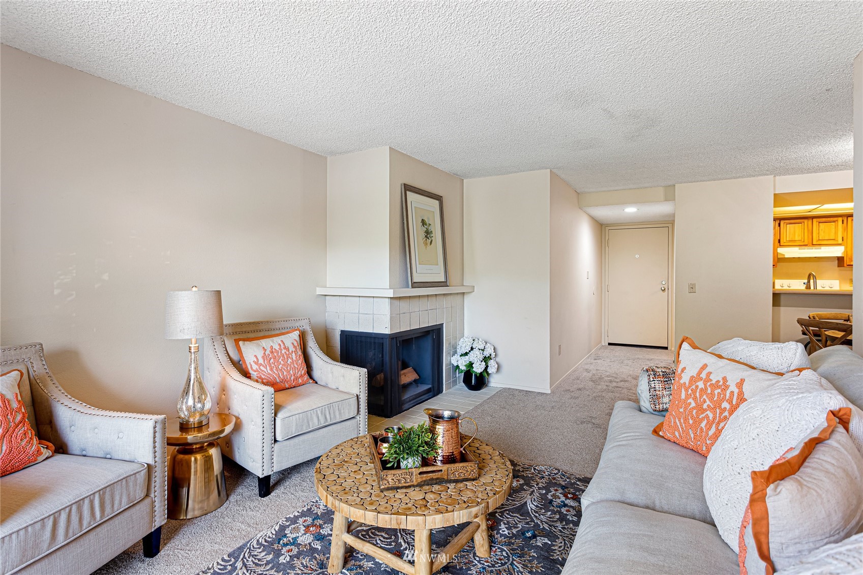611 Southwest 5th Court, Unit A304 Renton, WA 98057 - Photo 5 of 23 a living room with furniture a rug and a fireplace