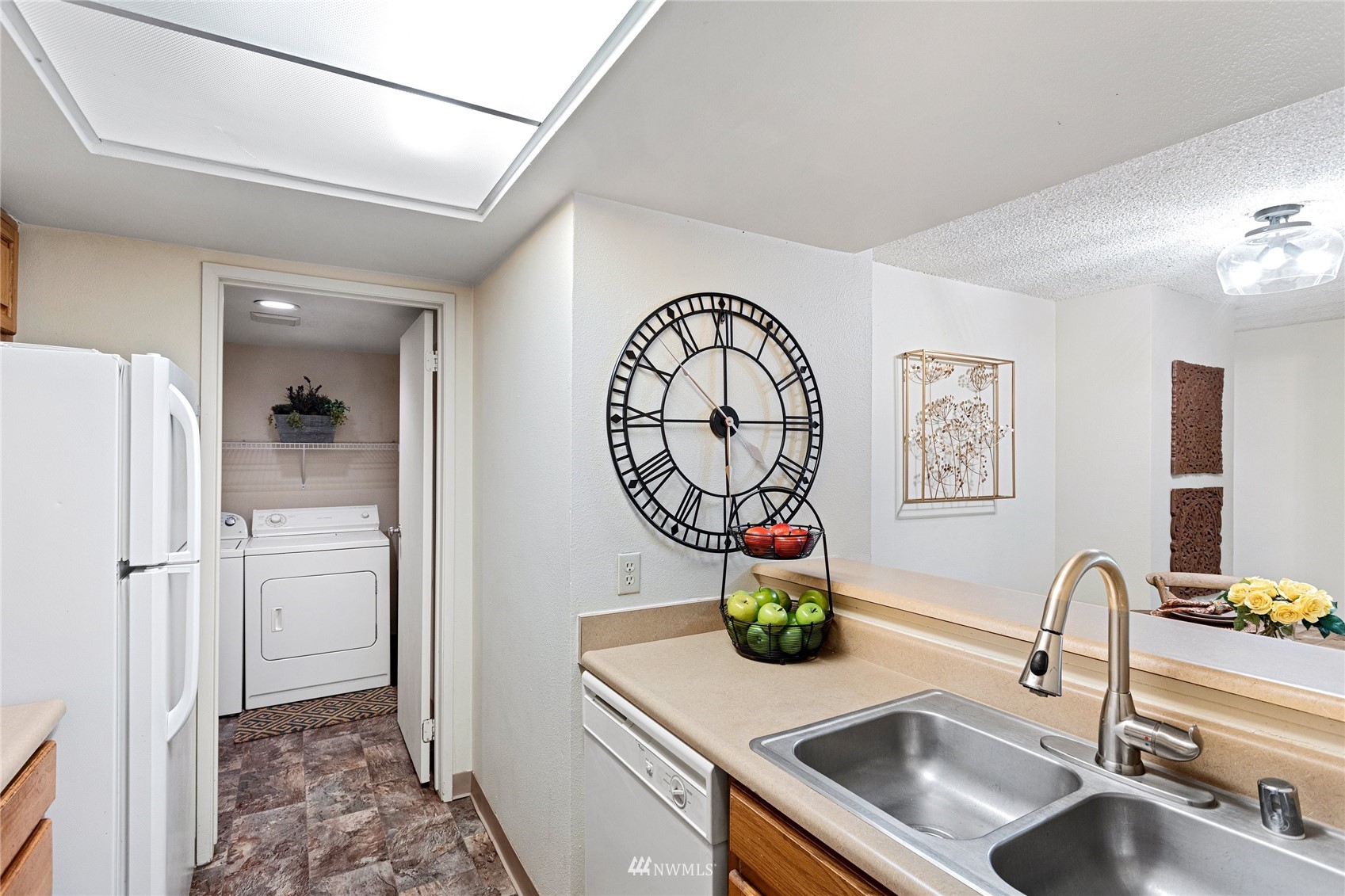 611 Southwest 5th Court, Unit A304 Renton, WA 98057 - Photo 8 of 23 a kitchen with a refrigerator and a sink