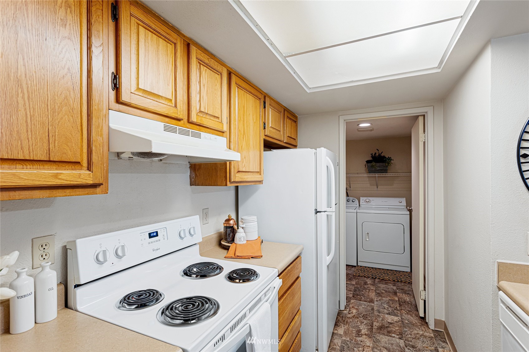 611 Southwest 5th Court, Unit A304 Renton, WA 98057 - Photo 9 of 23 a kitchen with stainless steel appliances granite countertop a refrigerator and a stove