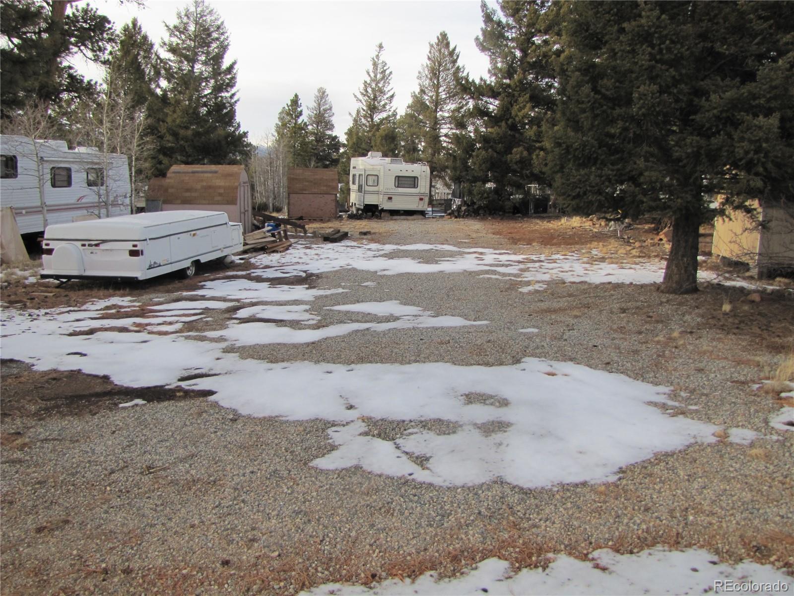 a view of a dirt road with a building in the background