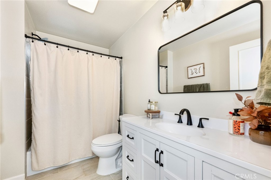 133 Tanner Way Orland, CA 95963 - Photo 13 of 25 a bathroom with a toilet a sink and a mirror