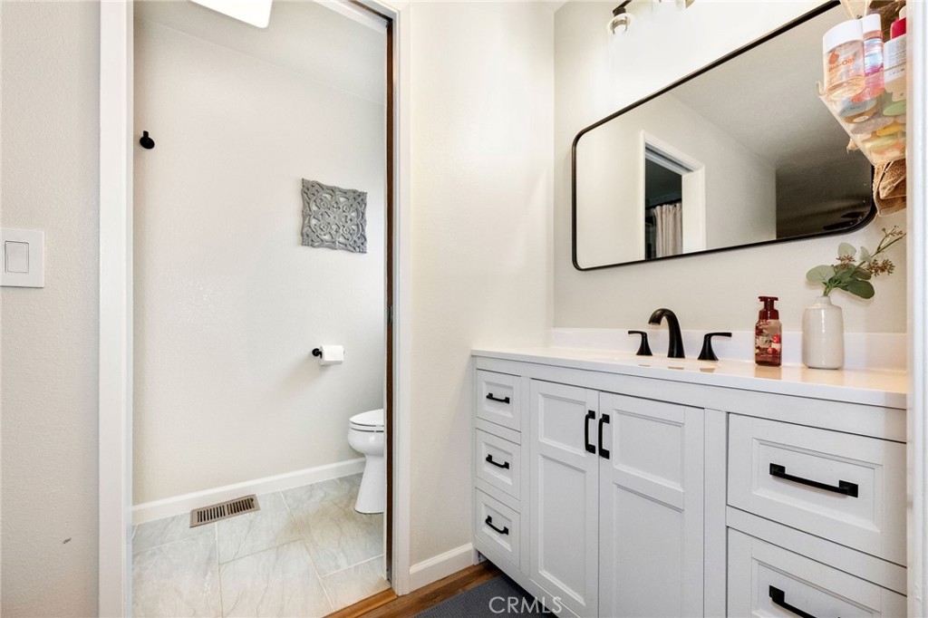 133 Tanner Way Orland, CA 95963 - Photo 18 of 25 a bathroom with a toilet sink and mirror