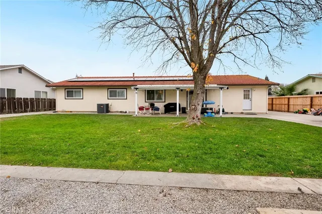 a front view of house with yard and green space