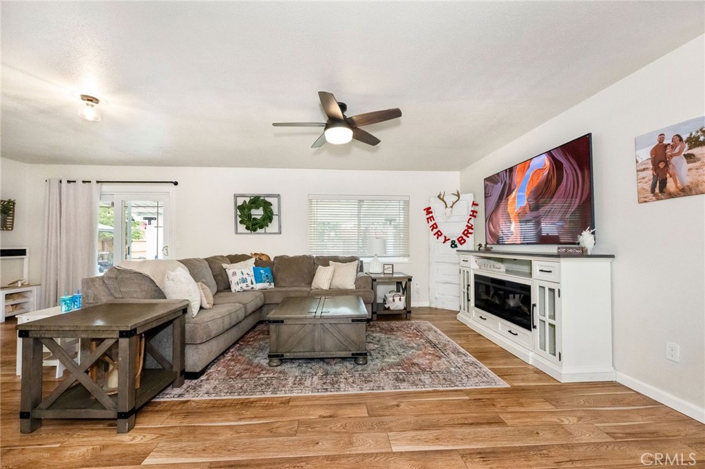 133 Tanner Way Orland, CA 95963 - Photo 3 of 25 a living room with furniture a fireplace and a flat screen tv