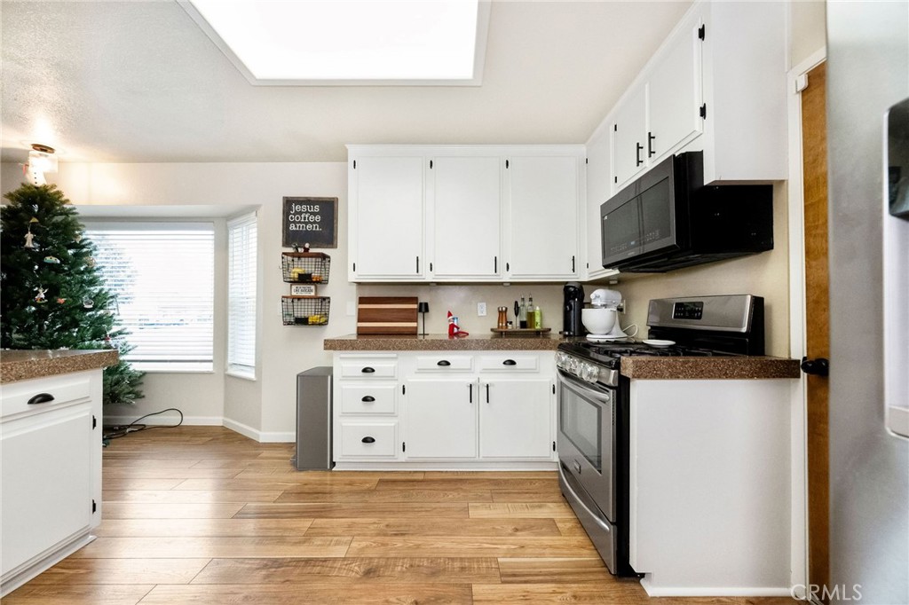 133 Tanner Way Orland, CA 95963 - Photo 6 of 25 a kitchen with stainless steel appliances a stove top oven a sink a counter space and cabinets