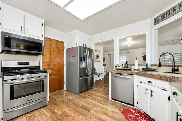 a kitchen with stainless steel appliances granite countertop a stove a refrigerator and a microwave