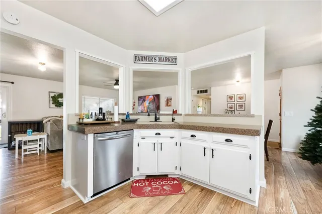 a kitchen with granite countertop a white cabinets and chandelier