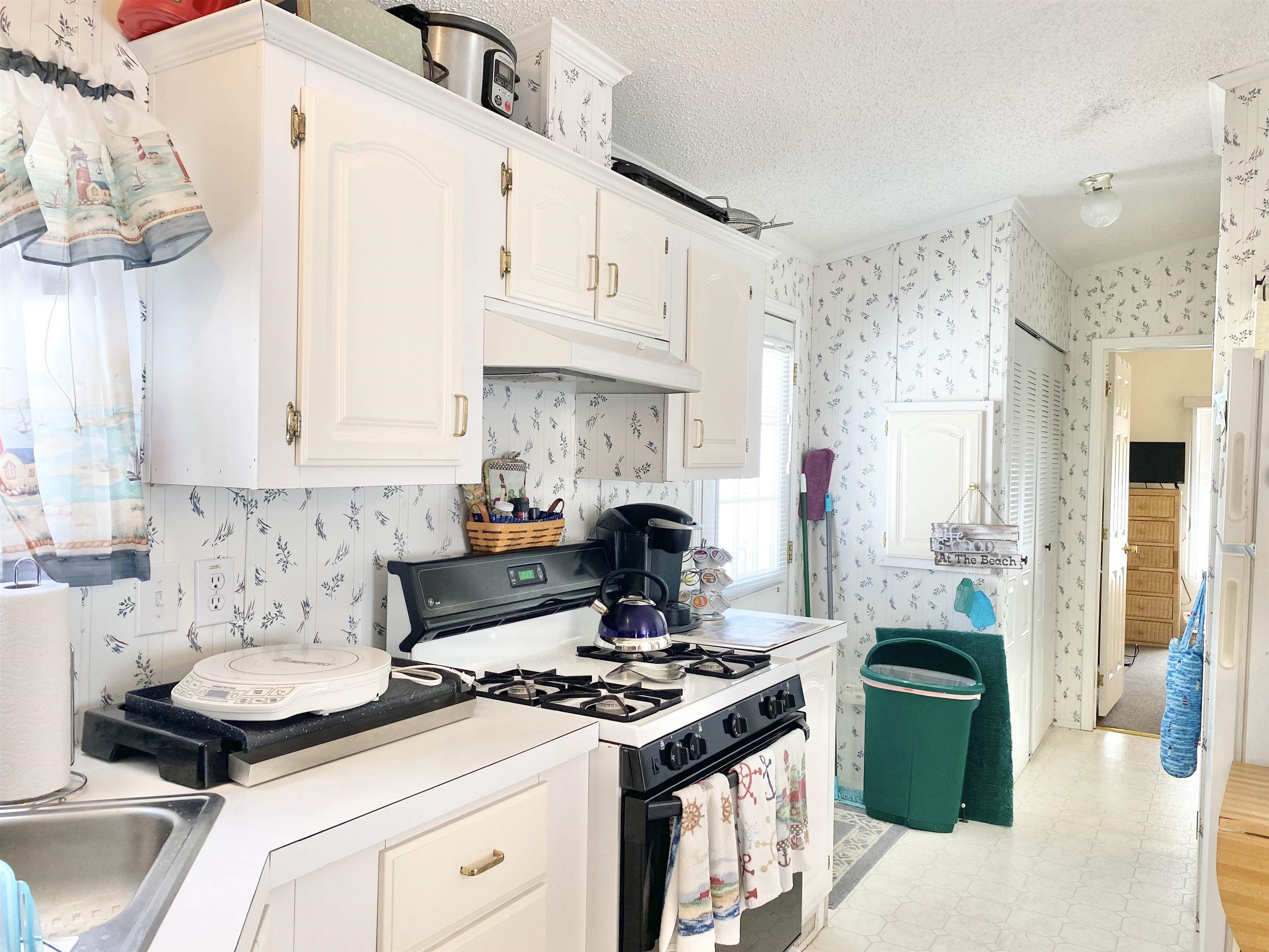 123 Shell North Cape May, NJ 08204 - Photo 12 of 29 a kitchen with a stove and white cabinets