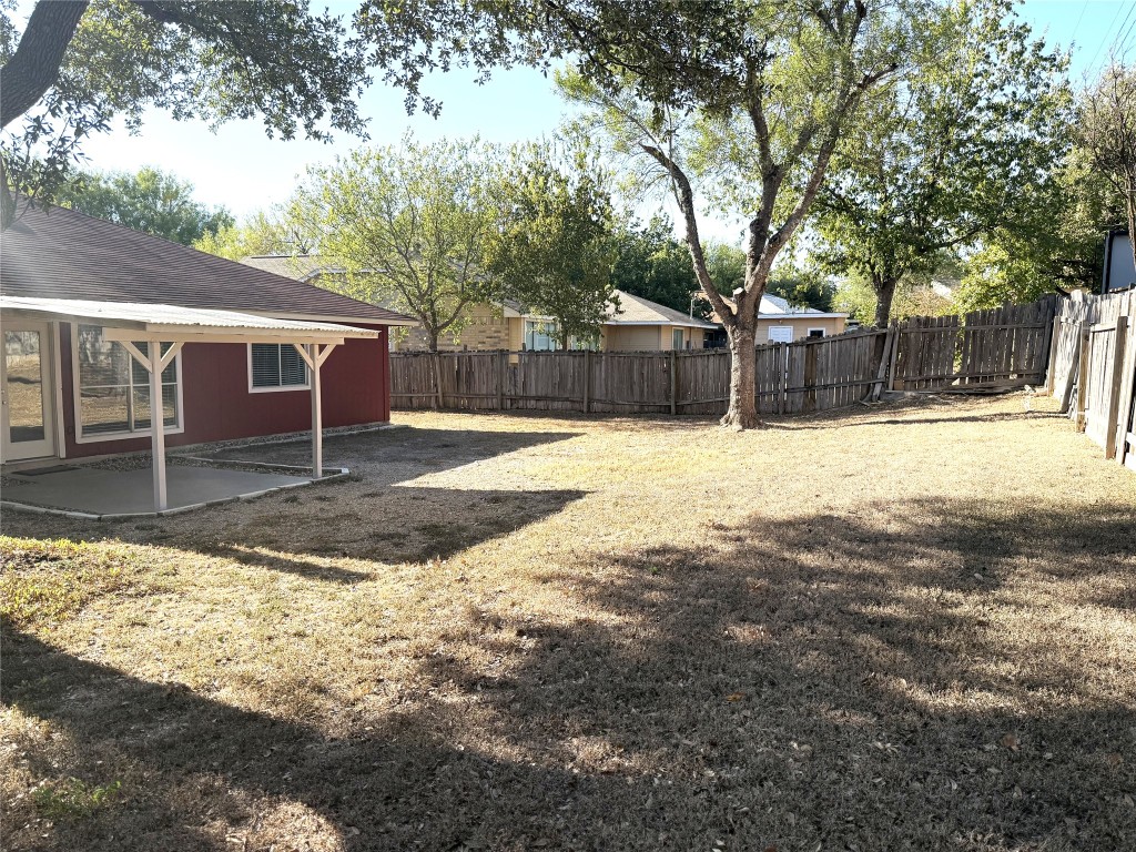 1412 Quail Run Road Pflugerville, TX 78660 - Photo 15 of 16 a front view of house with yard and trees in the background