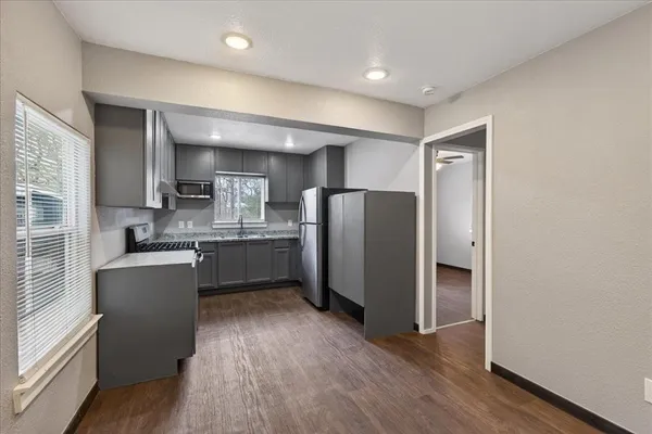 a kitchen with refrigerator and window