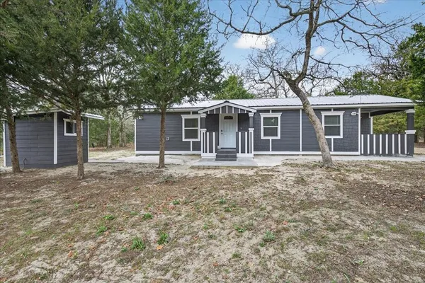 a house with trees in the background