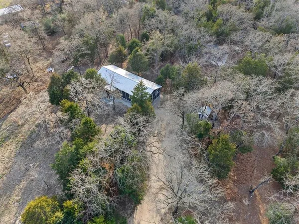 a backyard of a house with a yard and outdoor seating