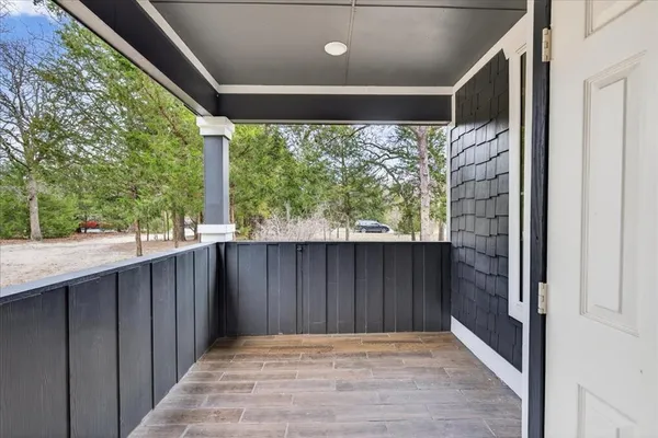 a view of a door and wooden floor