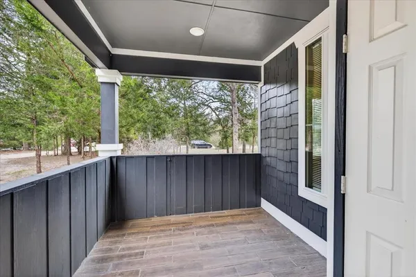 a view of a porch with wooden floor and outer view