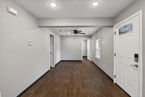 a view of a hallway with wooden floor
