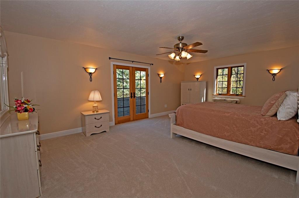 105 Lantern Circle McMurray, PA 15317 - Photo 12 of 25 a spacious bedroom with a bed and a chandelier