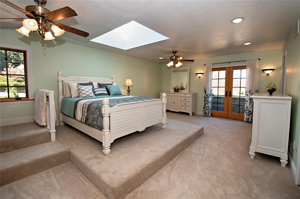 105 Lantern Circle McMurray, PA 15317 - Photo 15 of 25 a spacious bedroom with a bed couch chandelier and a window